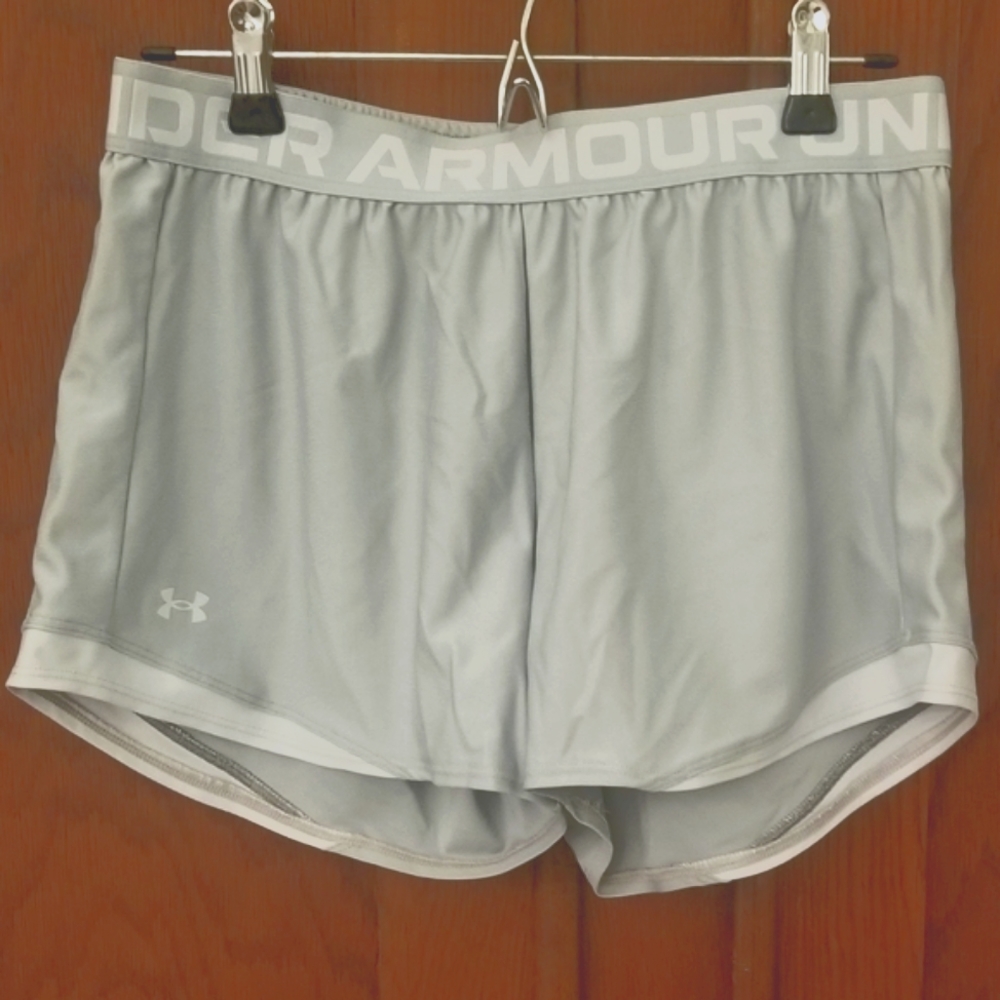 Under Armour running shorts. Light gray with white trim. Women's size M.